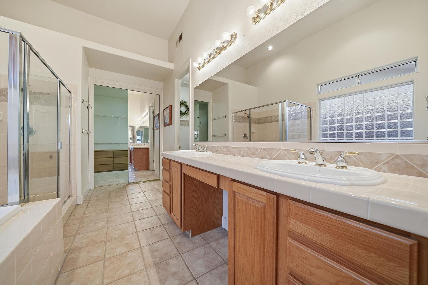 719 Shakeley Lane Ione, CA 95640 - Photo 42 of 68 a spacious bathroom with a granite countertop sink a mirror and a