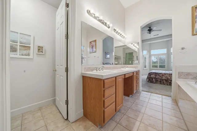 a view of a backyard with swimming pool and sitting area