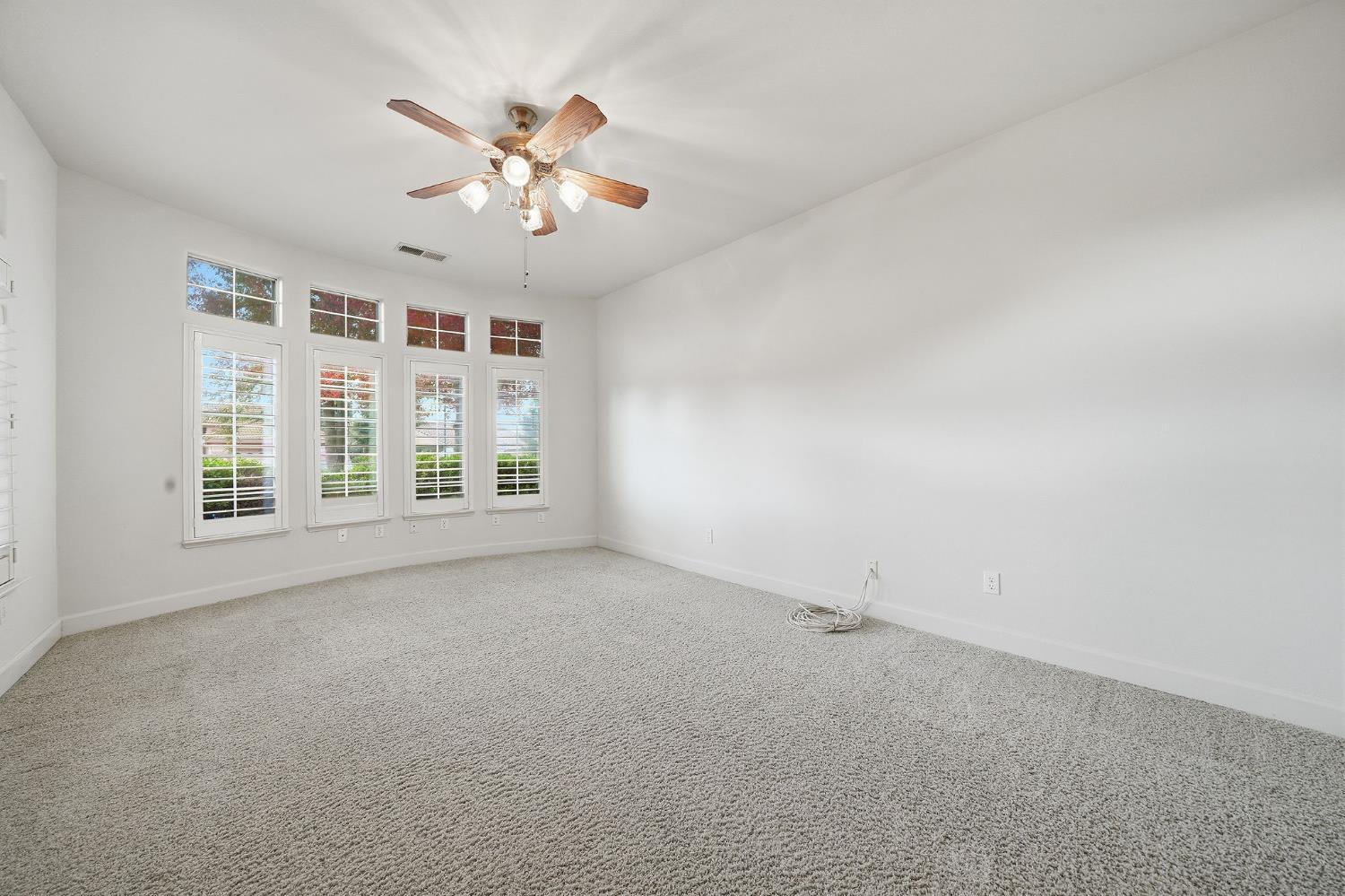 719 Shakeley Lane Ione, CA 95640 - Photo 47 of 68 an empty room with windows and ceiling fan
