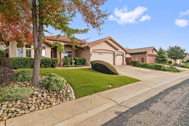 a view of front of house with a yard and garage
