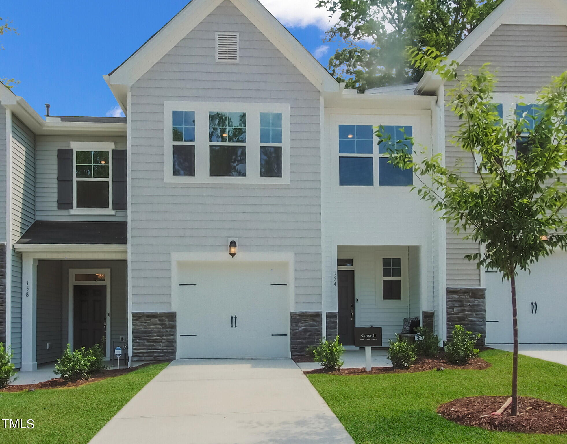 219 Aster Bloom Lane, Unit 394 Raleigh, NC 27610 - Photo 1 of 26 a front view of a house with a garden