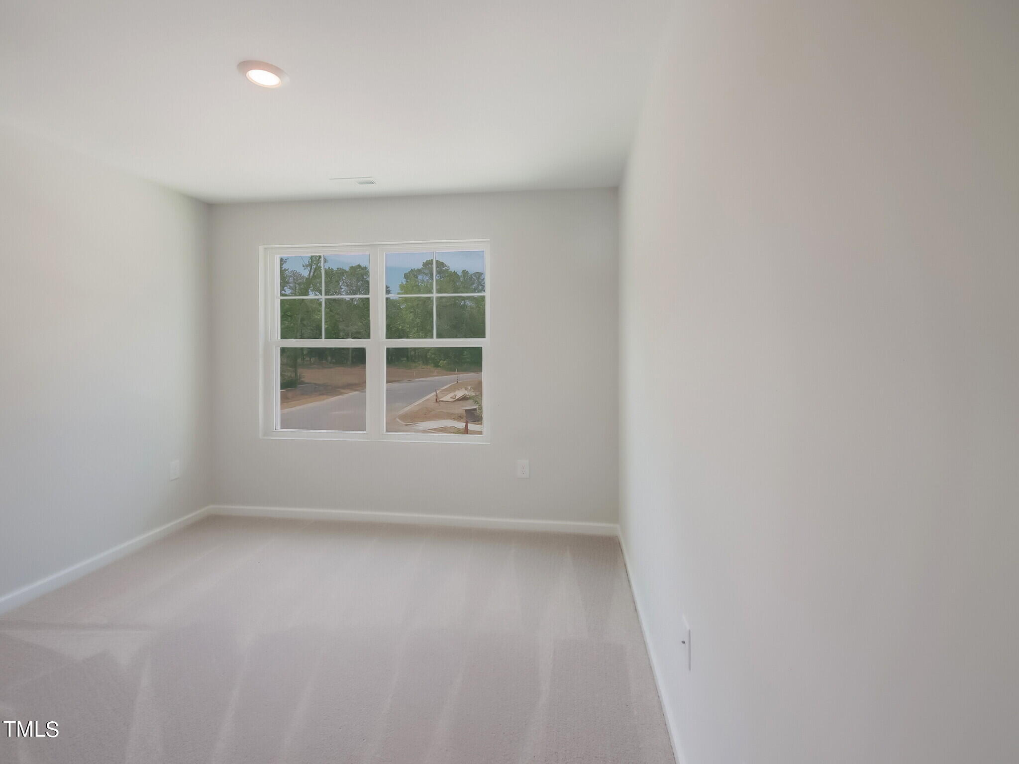 219 Aster Bloom Lane, Unit 394 Raleigh, NC 27610 - Photo 25 of 26 an empty room with a window