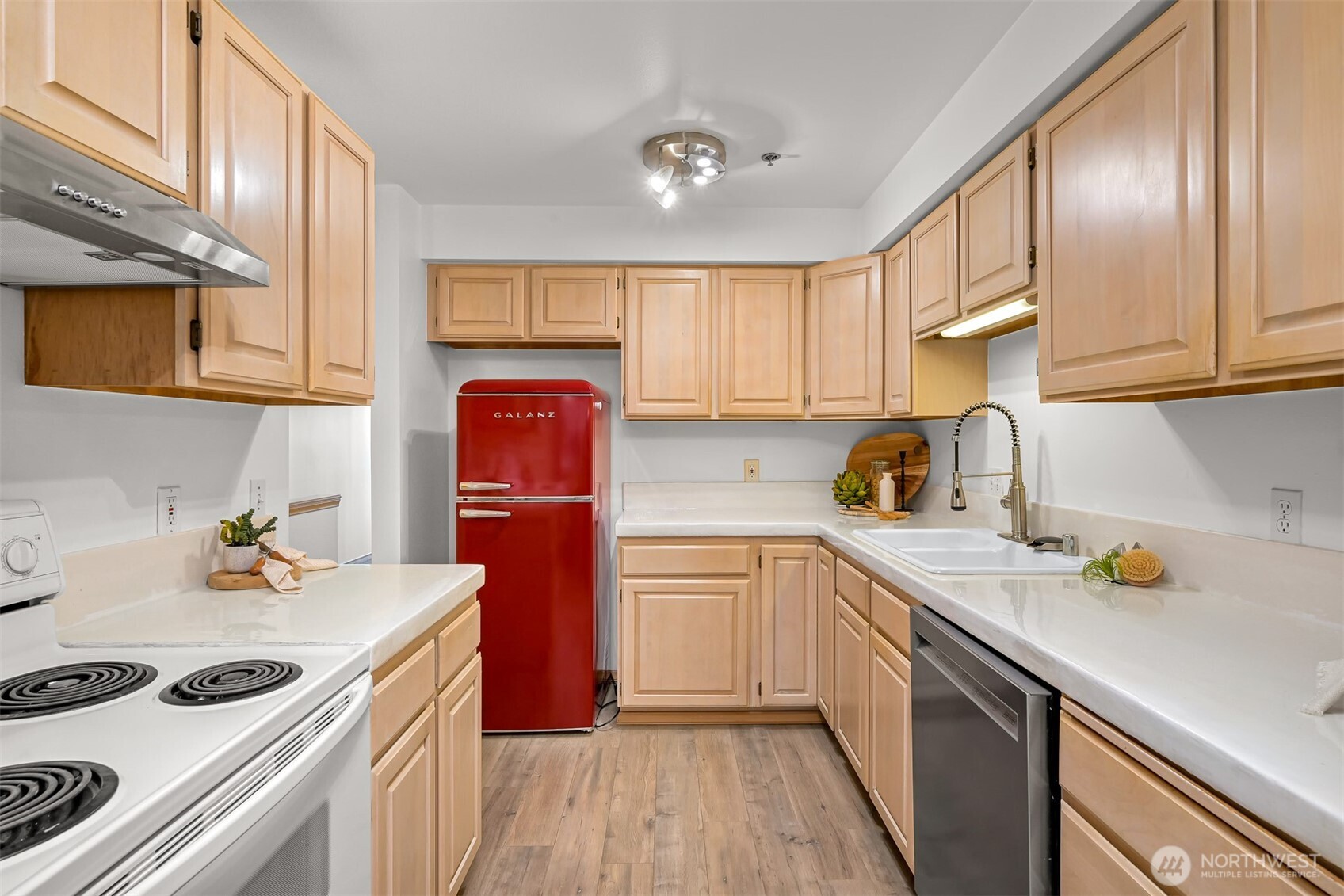705 North State Street, Unit 202 Bellingham, WA 98225 - Photo 12 of 26 a kitchen with a sink a stove and cabinets