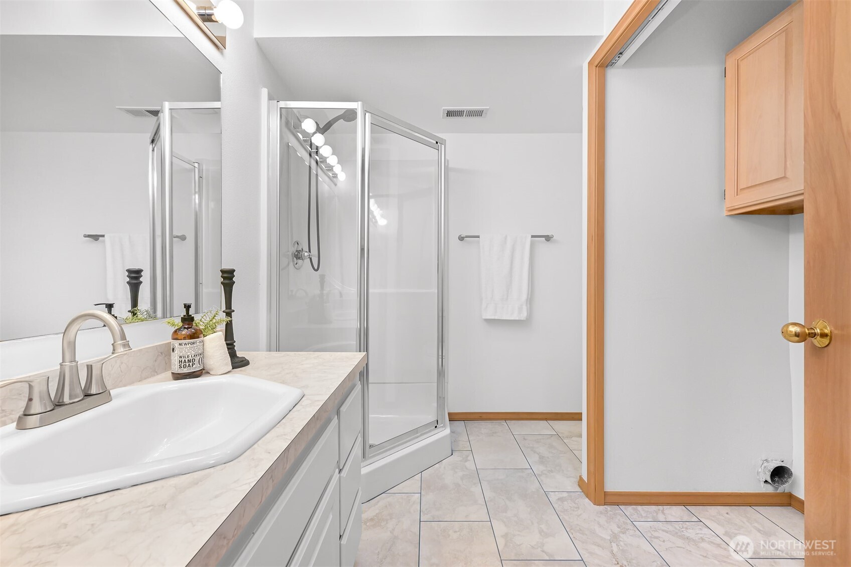 705 North State Street, Unit 202 Bellingham, WA 98225 - Photo 23 of 26 a bathroom with a sink and a mirror