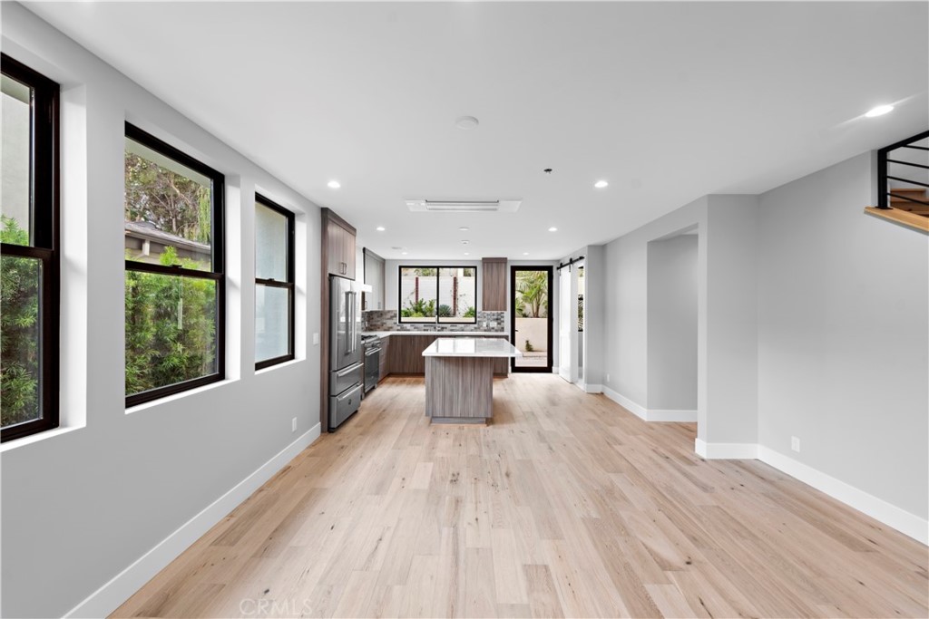 33903 Robles Drive Dana Point, CA 92629 - Photo 11 of 58 a view of a big room with wooden floor and windows