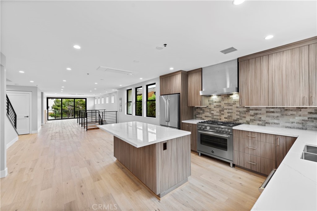 33903 Robles Drive Dana Point, CA 92629 - Photo 16 of 58 a large kitchen with stainless steel appliances granite countertop a large counter top a stove and a sink