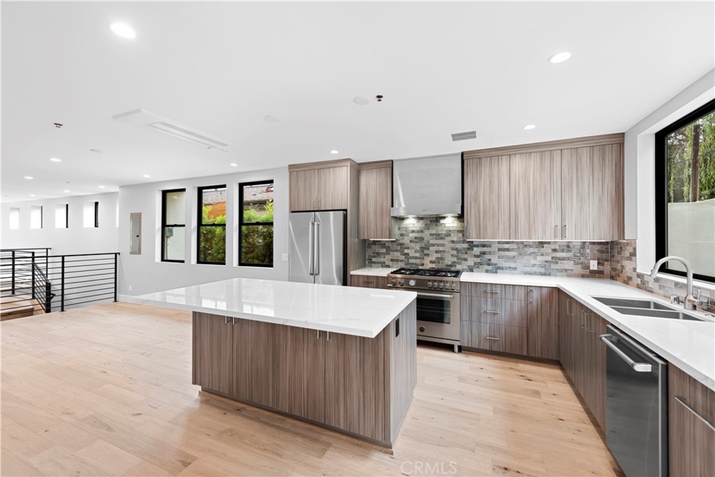 33903 Robles Drive Dana Point, CA 92629 - Photo 17 of 58 a large kitchen with stainless steel appliances granite countertop a stove refrigerator and a sink