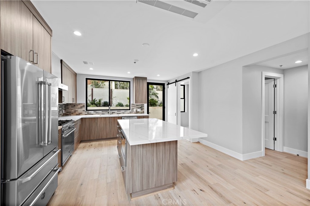 33903 Robles Drive Dana Point, CA 92629 - Photo 19 of 58 a large kitchen with stainless steel appliances granite countertop a large counter top a refrigerator and a sink