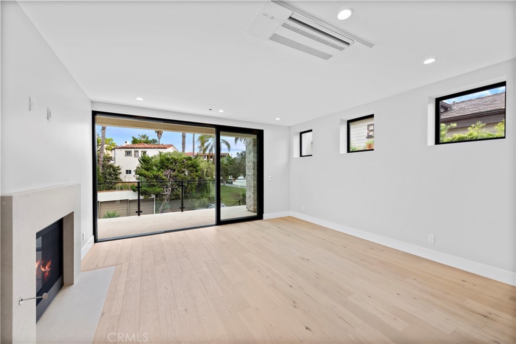 33903 Robles Drive Dana Point, CA 92629 - Photo 21 of 58 an empty room with sliding glass door and garden view