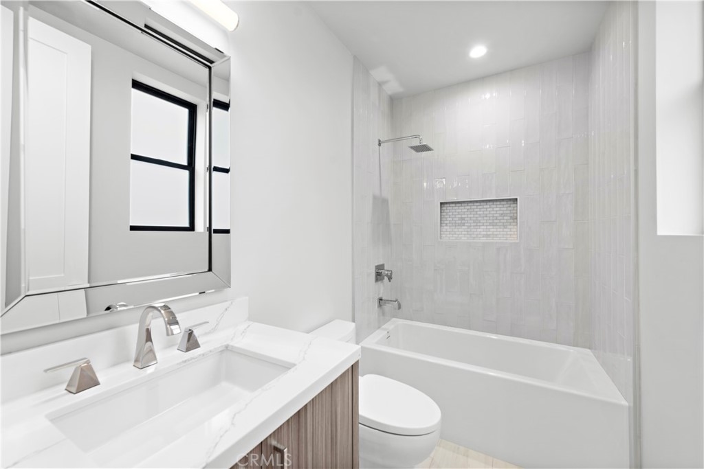 33903 Robles Drive Dana Point, CA 92629 - Photo 30 of 58 a bathroom with a bathtub shower sink vanity mirror and toilet