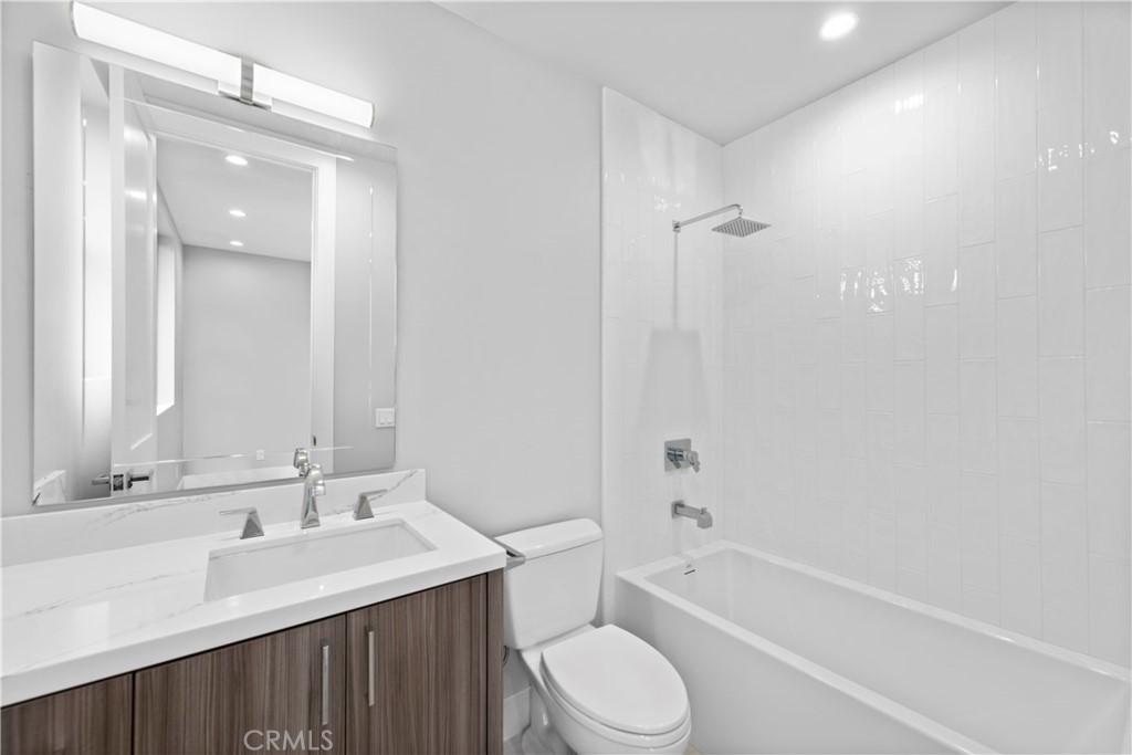 33903 Robles Drive Dana Point, CA 92629 - Photo 32 of 58 a bathroom with a bathtub shower sink mirror vanity and a toilet