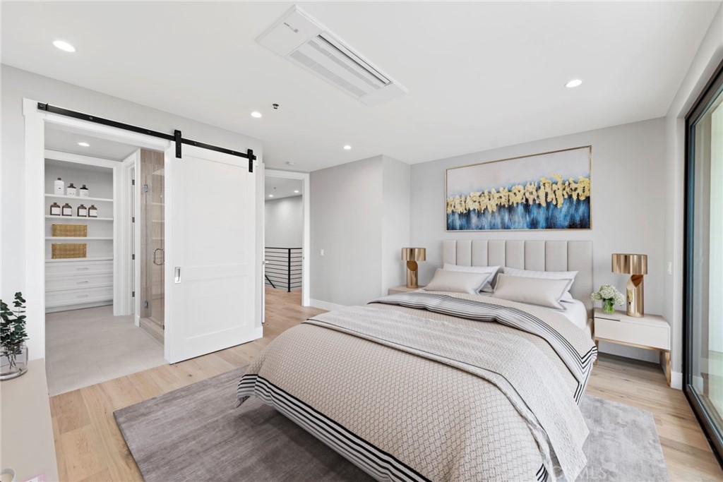 33903 Robles Drive Dana Point, CA 92629 - Photo 34 of 58 a spacious bedroom with a bed and a walk in closet