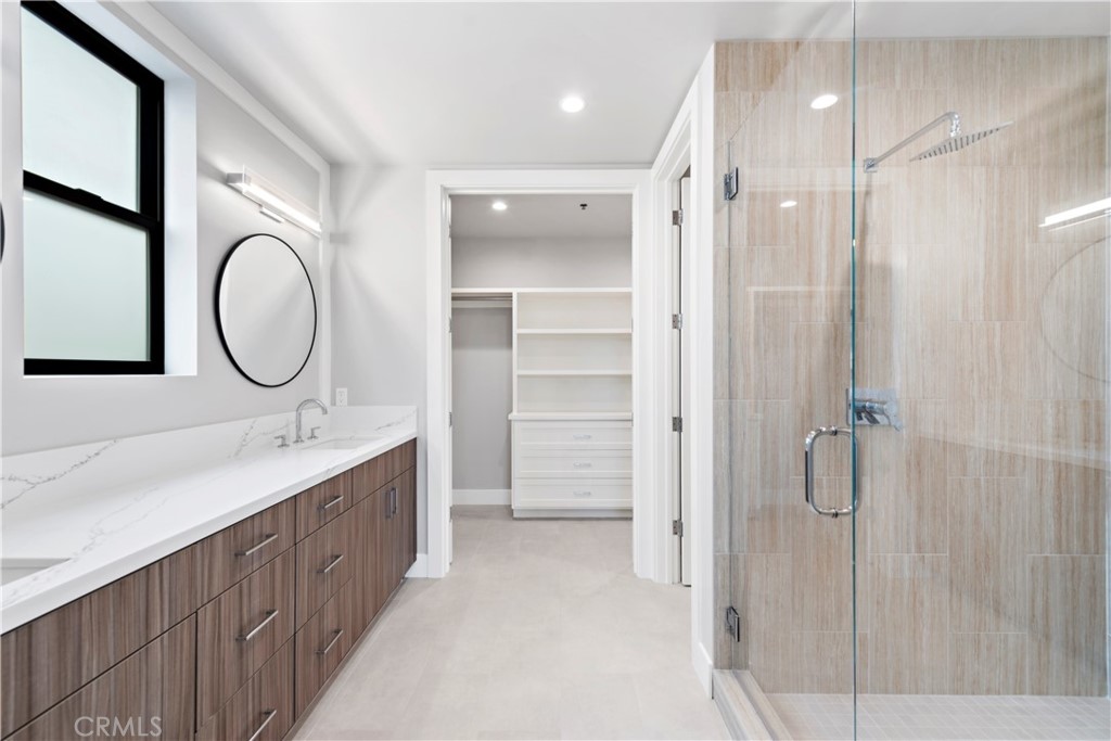 33903 Robles Drive Dana Point, CA 92629 - Photo 36 of 58 a bathroom with a double vanity sink mirror and shower