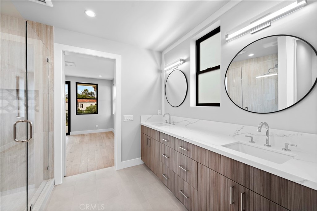 33903 Robles Drive Dana Point, CA 92629 - Photo 38 of 58 a bathroom with a double vanity sink and a mirror
