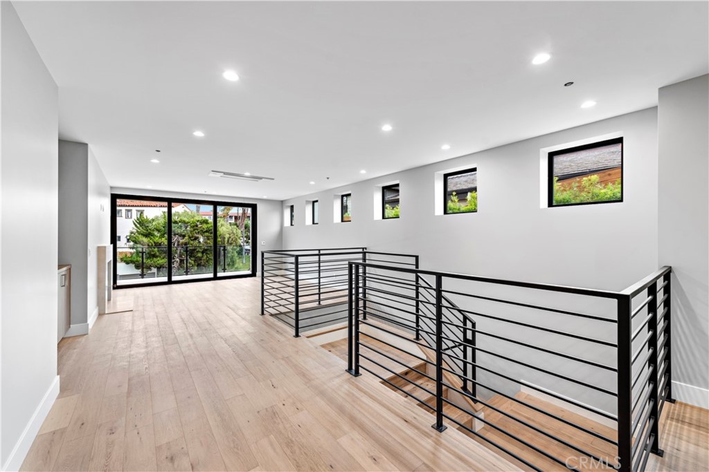 33903 Robles Drive Dana Point, CA 92629 - Photo 4 of 58 a view of a hallway with wooden floor and windows