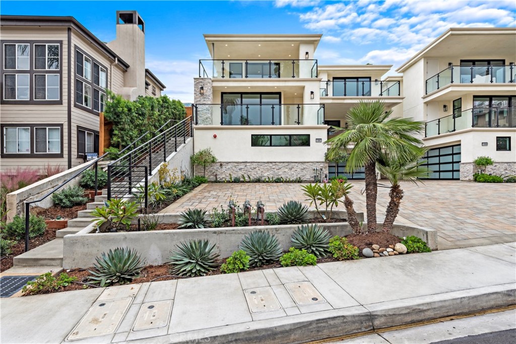 33903 Robles Drive Dana Point, CA 92629 - Photo 55 of 58 a front view of a residential apartment building with a yard
