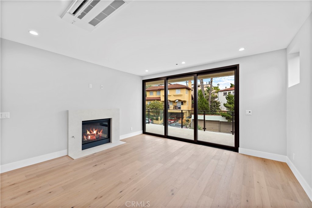 33903 Robles Drive Dana Point, CA 92629 - Photo 6 of 58 a view of an empty room with a window and a fireplace