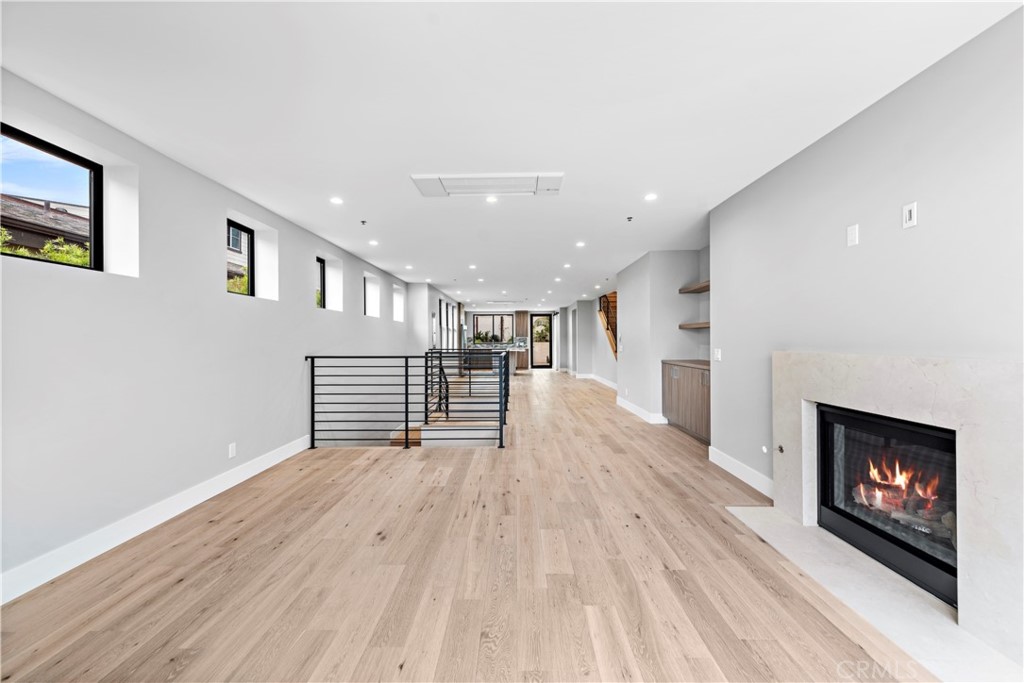 33903 Robles Drive Dana Point, CA 92629 - Photo 9 of 58 a view of empty room with wooden floor and fireplace