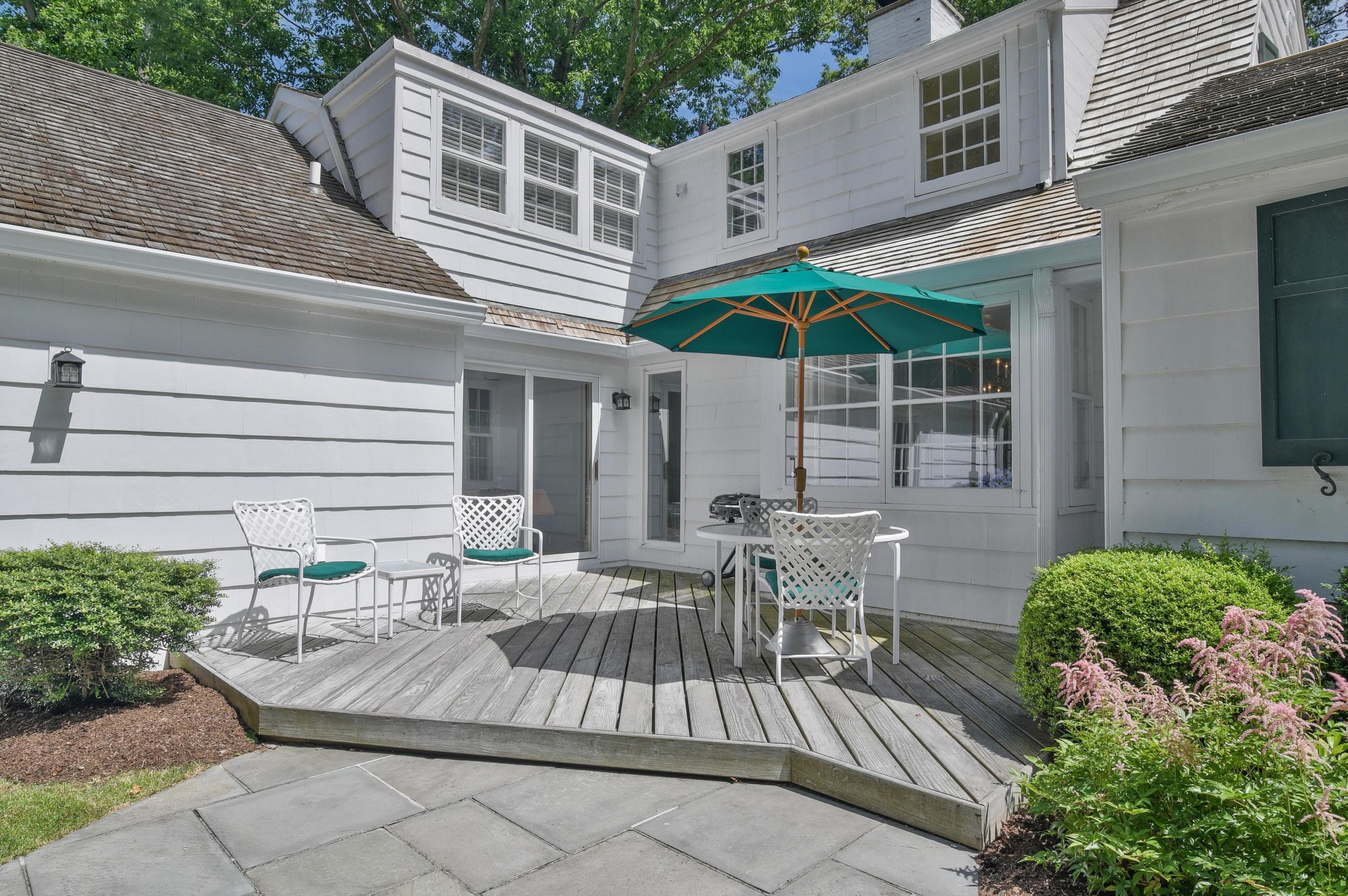 15 Sylvan Road Darien, CT 06820 - Photo 12 of 18 a view of a patio with table and chairs under an umbrella