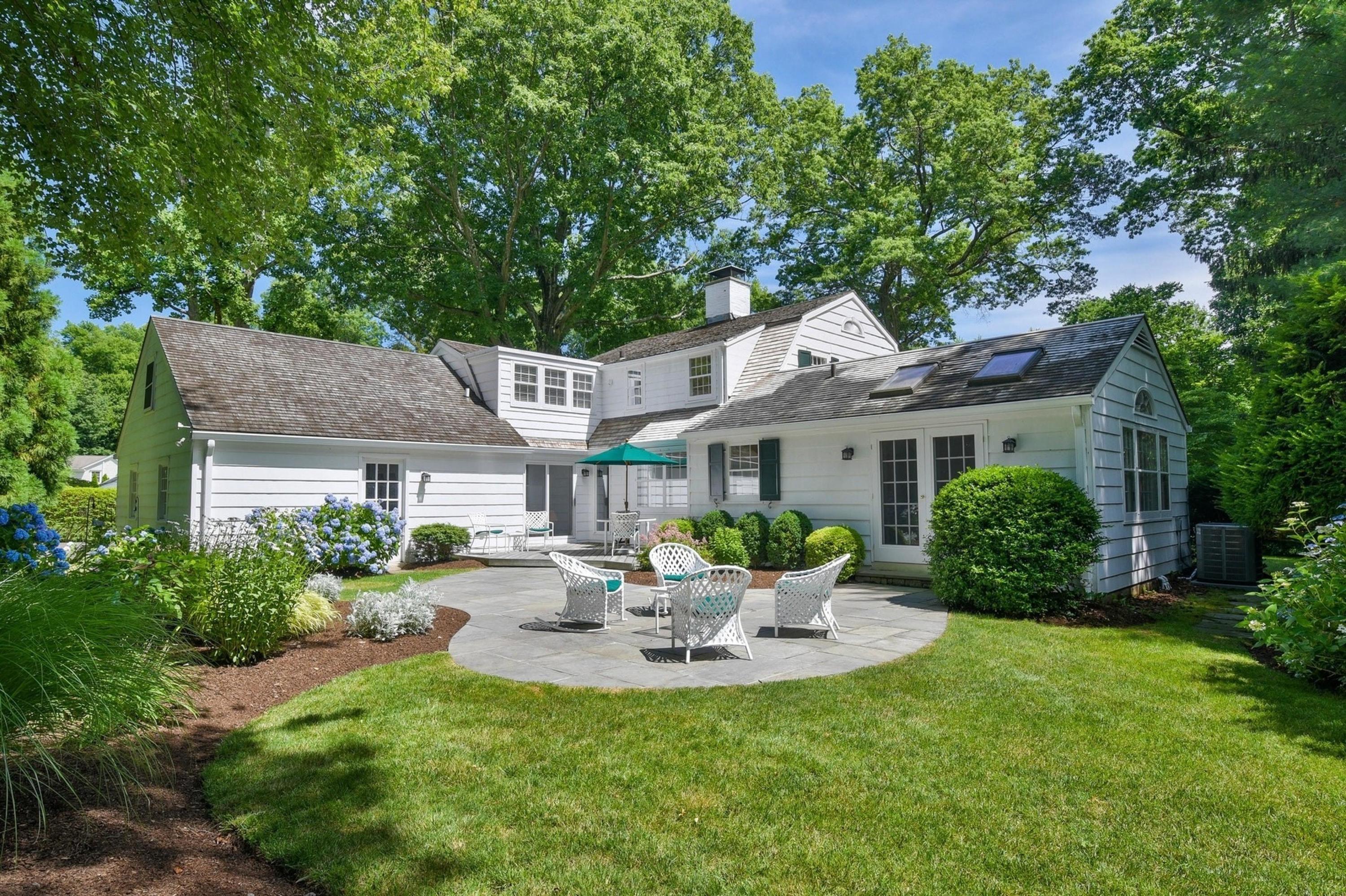 15 Sylvan Road Darien, CT 06820 - Photo 14 of 18 a view of a patio with table and chairs potted plants and large tree