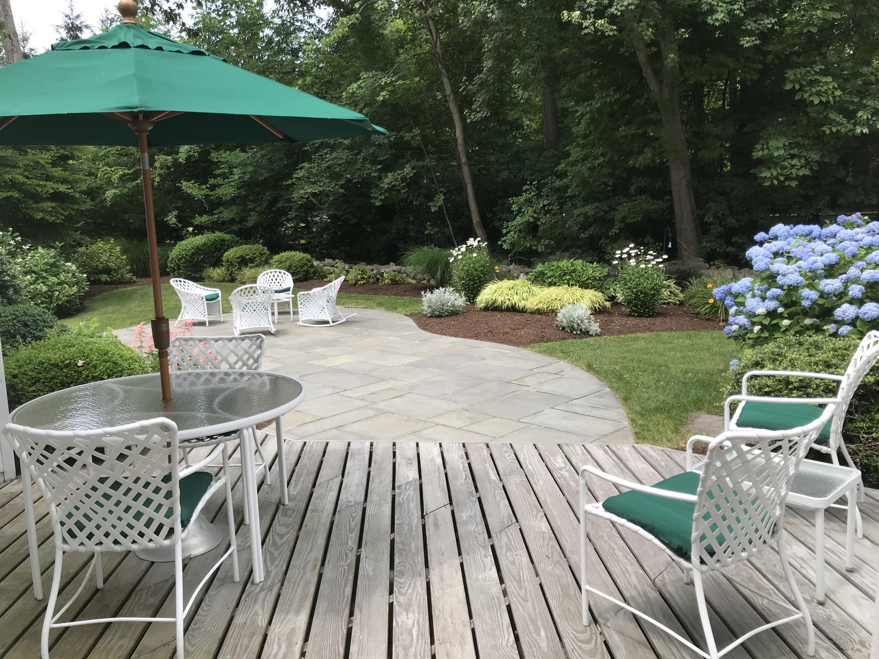 15 Sylvan Road Darien, CT 06820 - Photo 15 of 18 a view of a table and chairs under an umbrella