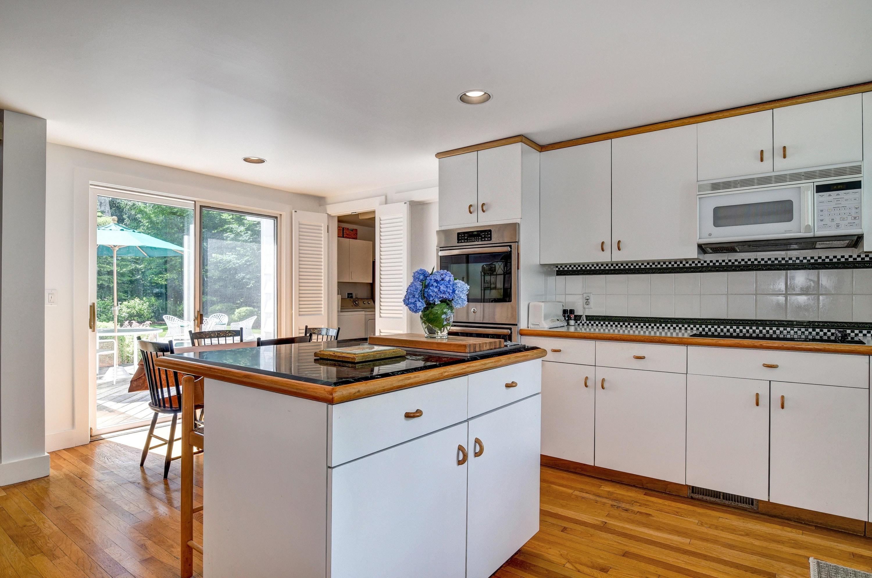 15 Sylvan Road Darien, CT 06820 - Photo 8 of 18 a kitchen with stainless steel appliances granite countertop a stove a sink and white cabinets