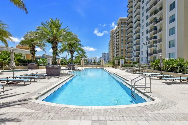 a view of a swimming pool with outdoor seating