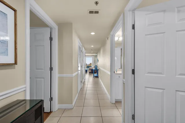 a view of a hallway with a livingroom and furniture