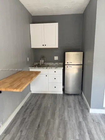 a view of kitchen with wooden floor