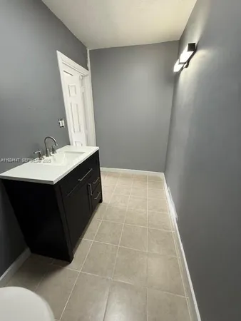 a bathroom with a sink vanity and a mirror