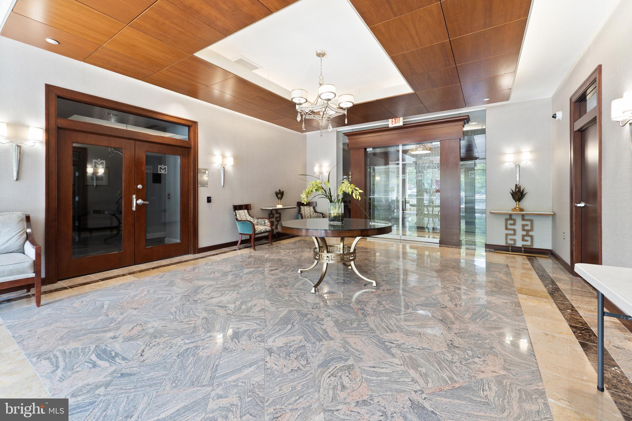 11760 Sunrise Valley Drive, Unit 809 Reston, VA 20191 - Photo 13 of 13 a living room with furniture and a chandelier