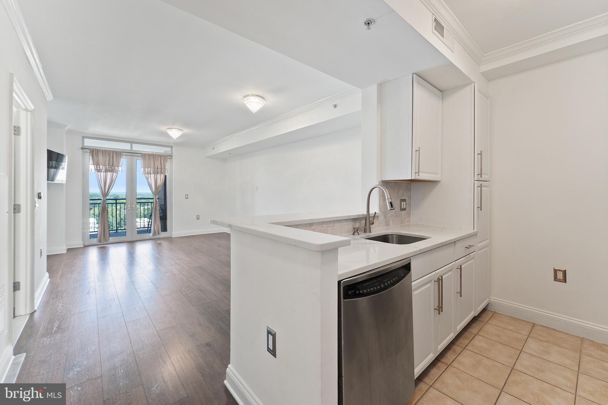 11760 Sunrise Valley Drive, Unit 809 Reston, VA 20191 - Photo 7 of 13 a kitchen that has a sink a stove and wooden floor