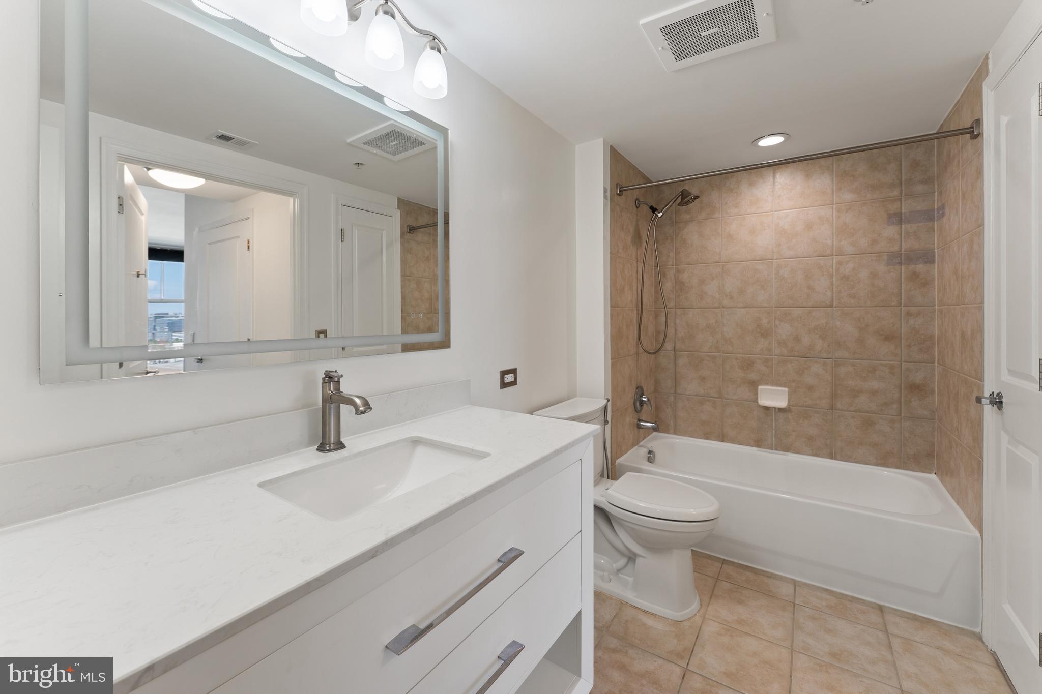 11760 Sunrise Valley Drive, Unit 809 Reston, VA 20191 - Photo 9 of 13 a bathroom with a sink a toilet and shower
