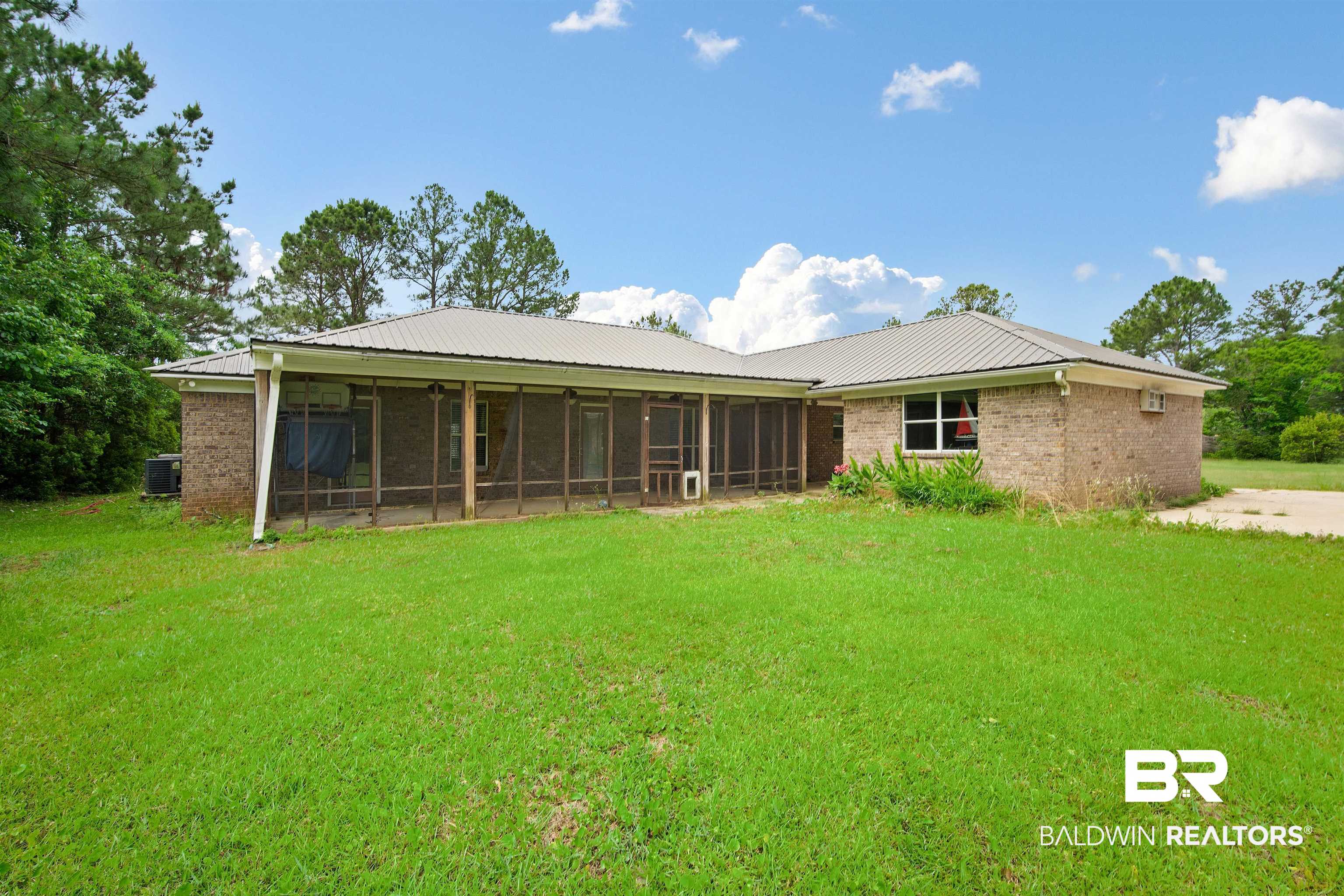 3010 Drag Strip Lane Coden, AL 36523 - Photo 34 of 44 Back of house with a sunroom, a yard, and metal roof