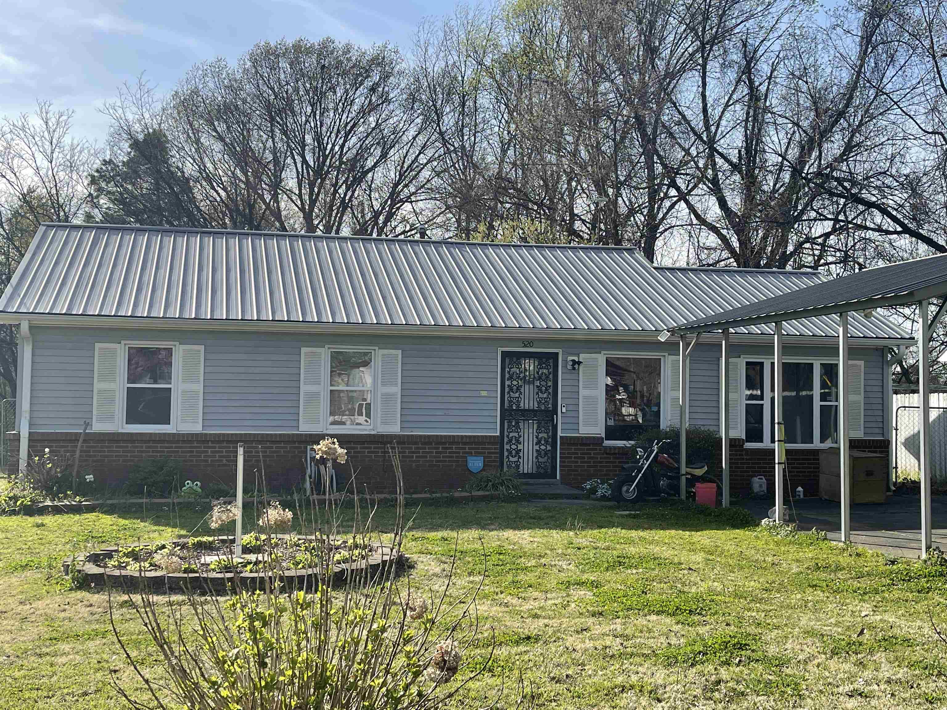 520 Sunset Street Ripley, TN 38063 - Photo 1 of 1 a front view of a house with garden