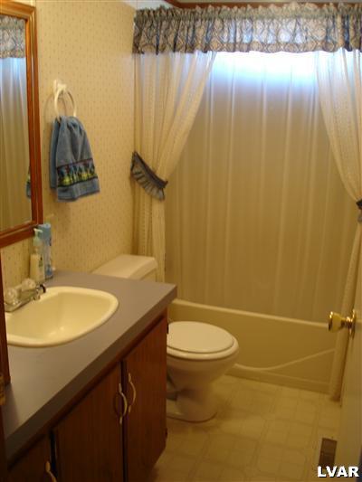 3066 Audrey Drive Coplay, PA 18037 - Photo 6 of 7 a bathroom with a granite countertop sink toilet and shower