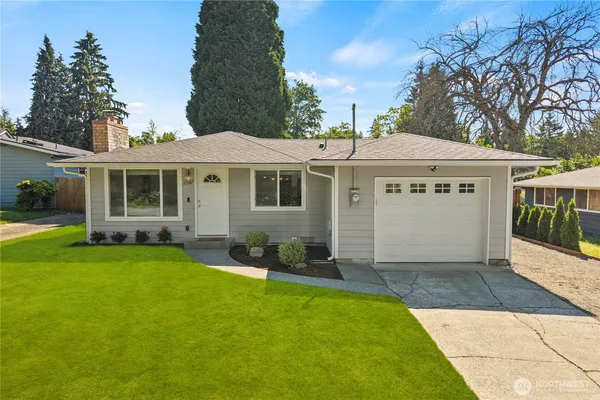 a view of a house with a yard and sitting area