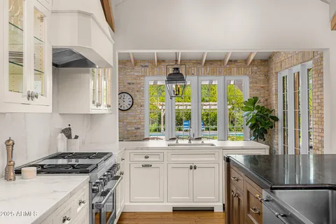 a kitchen with stainless steel appliances kitchen island granite countertop a sink and cabinets
