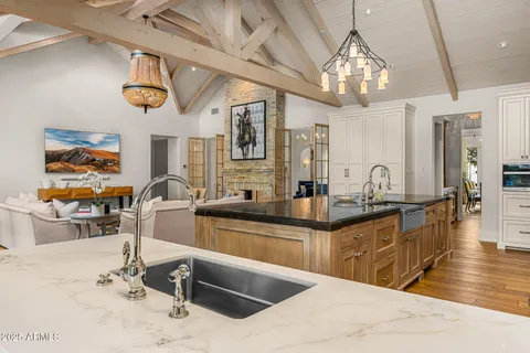 a spacious bedroom with a bed mirror and couch