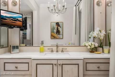 a bedroom with a bed and a chandelier