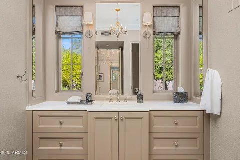 a bedroom with a bed and a chandelier