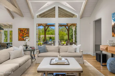 a living room with furniture a large window and a fireplace