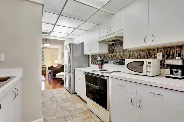 a kitchen with stainless steel appliances granite countertop a sink a stove and cabinets