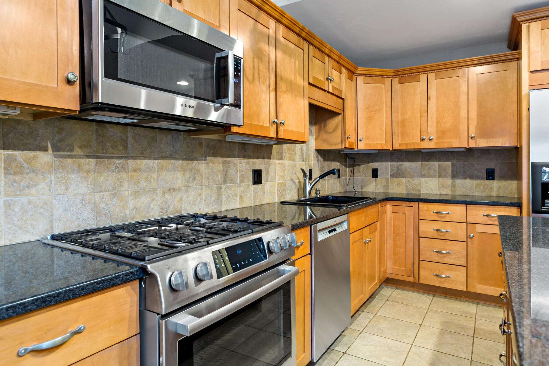 4 Gold Leaf Lane Mashpee, MA 02649 - Photo 5 of 33 a kitchen with stainless steel appliances granite countertop a stove a sink and a microwave