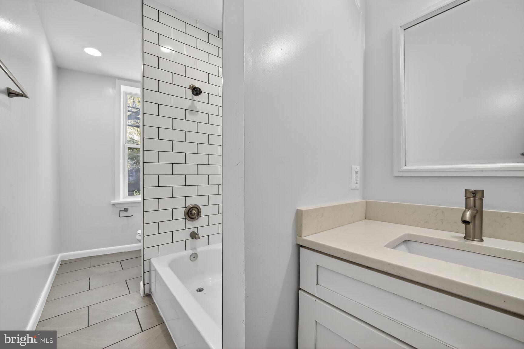 15 S Street Northeast, Unit 1 Washington, DC 20002 - Photo 11 of 12 a bathroom with a bathtub and a sink