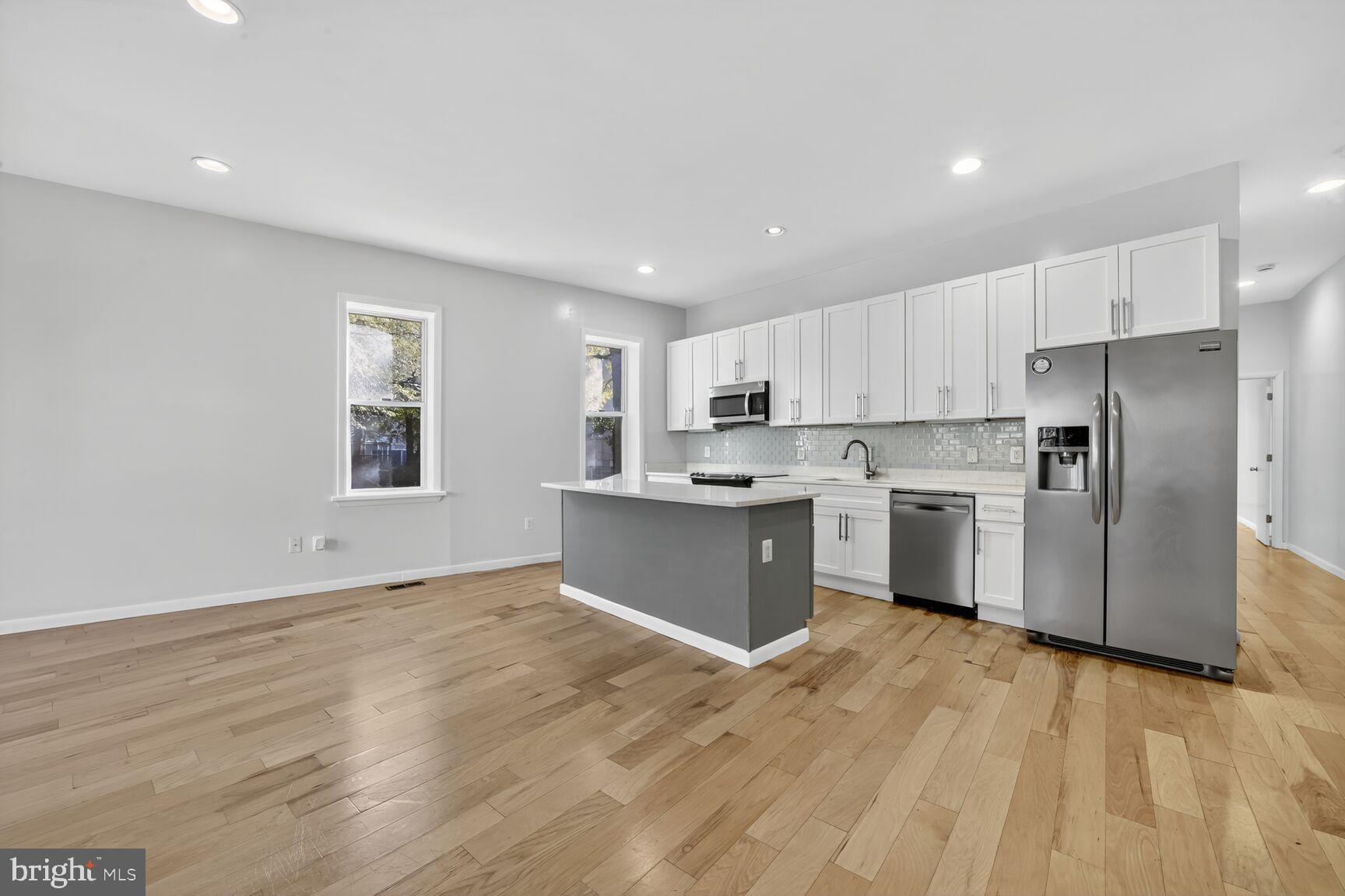 15 S Street Northeast, Unit 1 Washington, DC 20002 - Photo 3 of 12 a kitchen with stainless steel appliances a refrigerator sink and cabinets