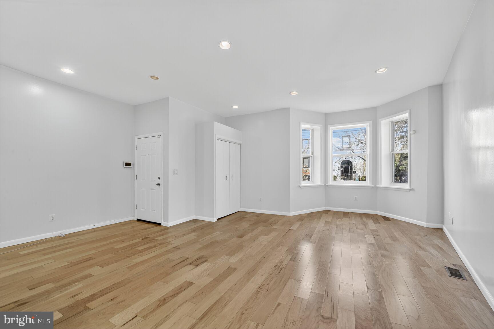 15 S Street Northeast, Unit 1 Washington, DC 20002 - Photo 6 of 12 a view of an empty room with wooden floor and window