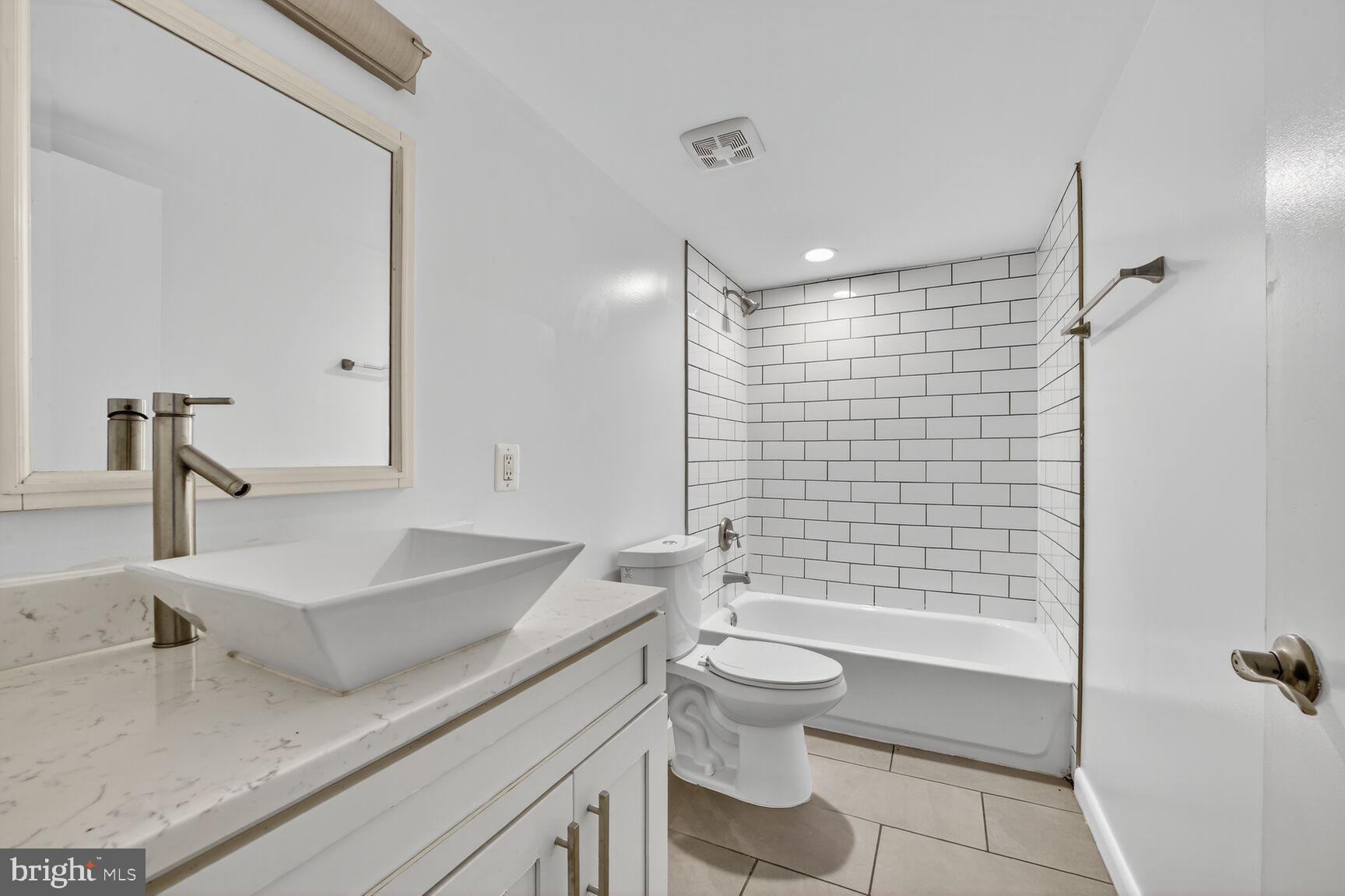 15 S Street Northeast, Unit 1 Washington, DC 20002 - Photo 9 of 12 a bathroom with a sink a toilet and shower