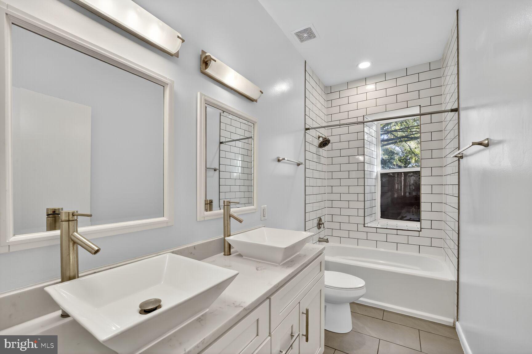 15 S Street Northeast, Unit 1 Washington, DC 20002 - Photo 10 of 12 a bathroom with a sink toilet tub and shower