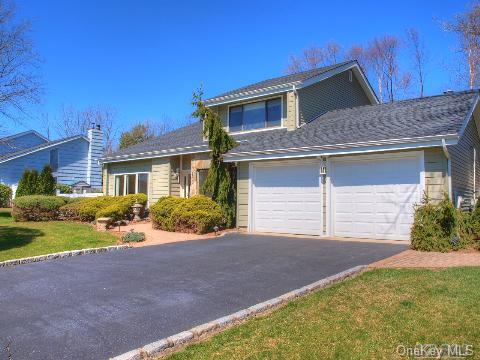 26 Timber Ridge Drive Commack, NY 11725 - Photo 1 of 1 a front view of a house with a yard and garage